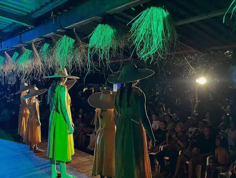 Dancers with palm-fibre headdresses perform at night before the audience in Galeras.